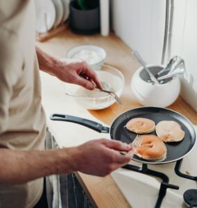man making pancakes on the stove